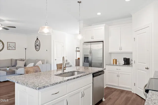 a kitchen with center island white cabinets and white appliances