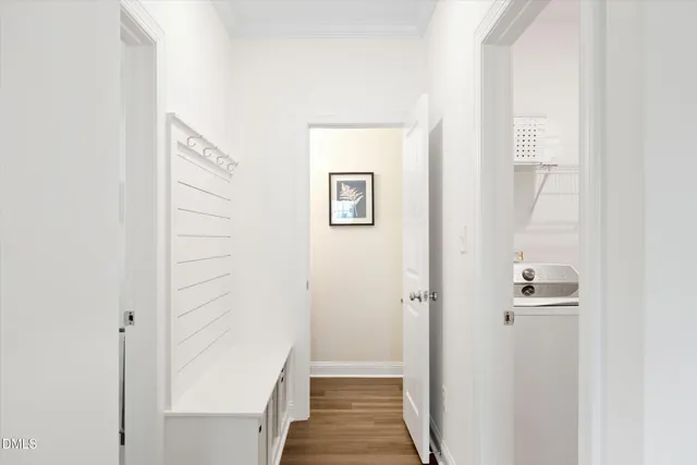 a view of a hallway with wooden floor