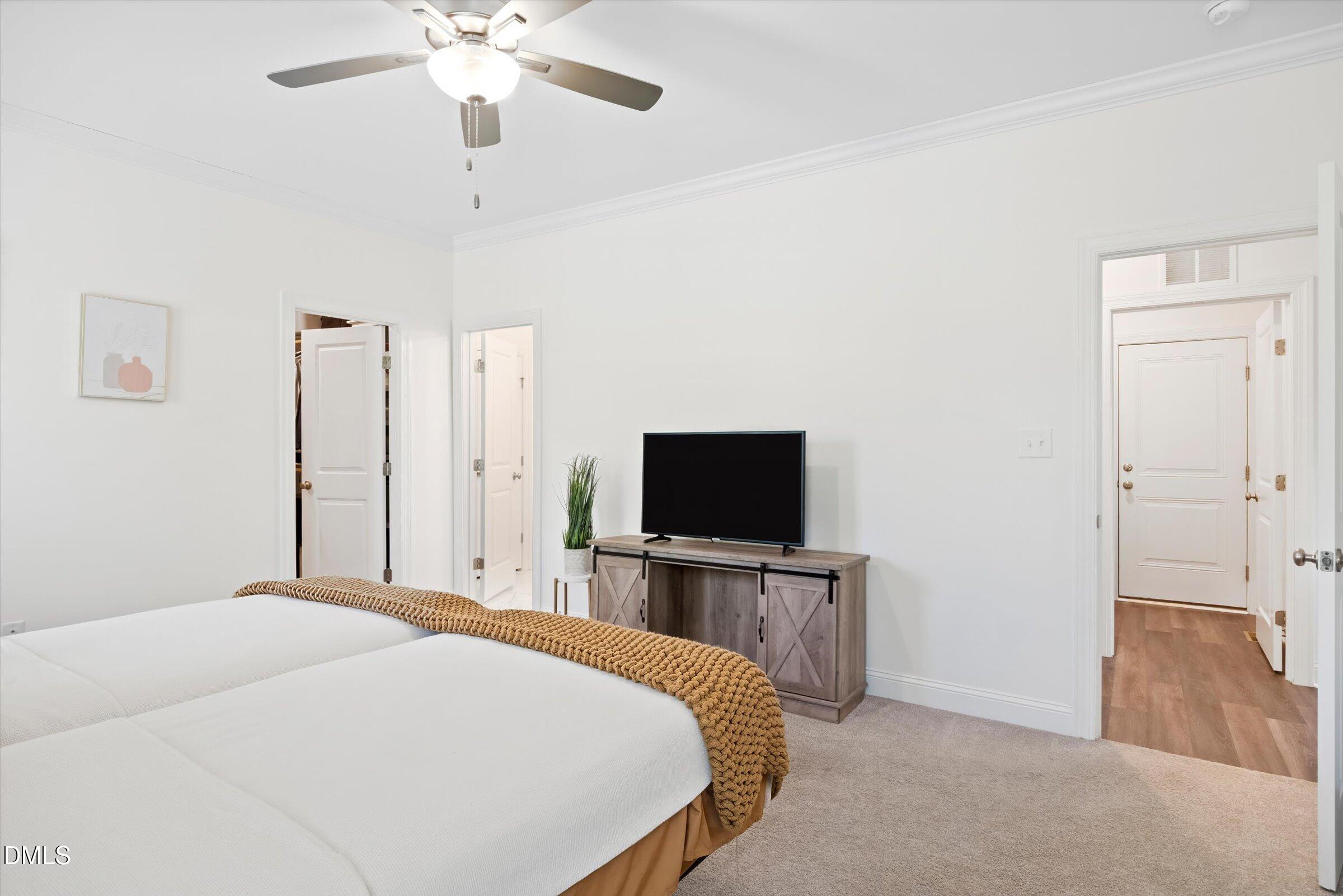 116 Nairn Street Fayetteville, NC 28311 - Photo 22 of 56 a bedroom with a bed and a flat tv screen on a dresser