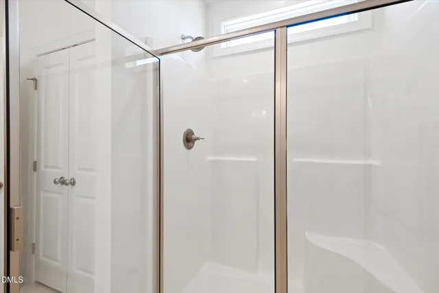 a bathroom with a glass shower door