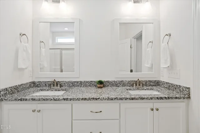a bathroom with sink granite and vanity