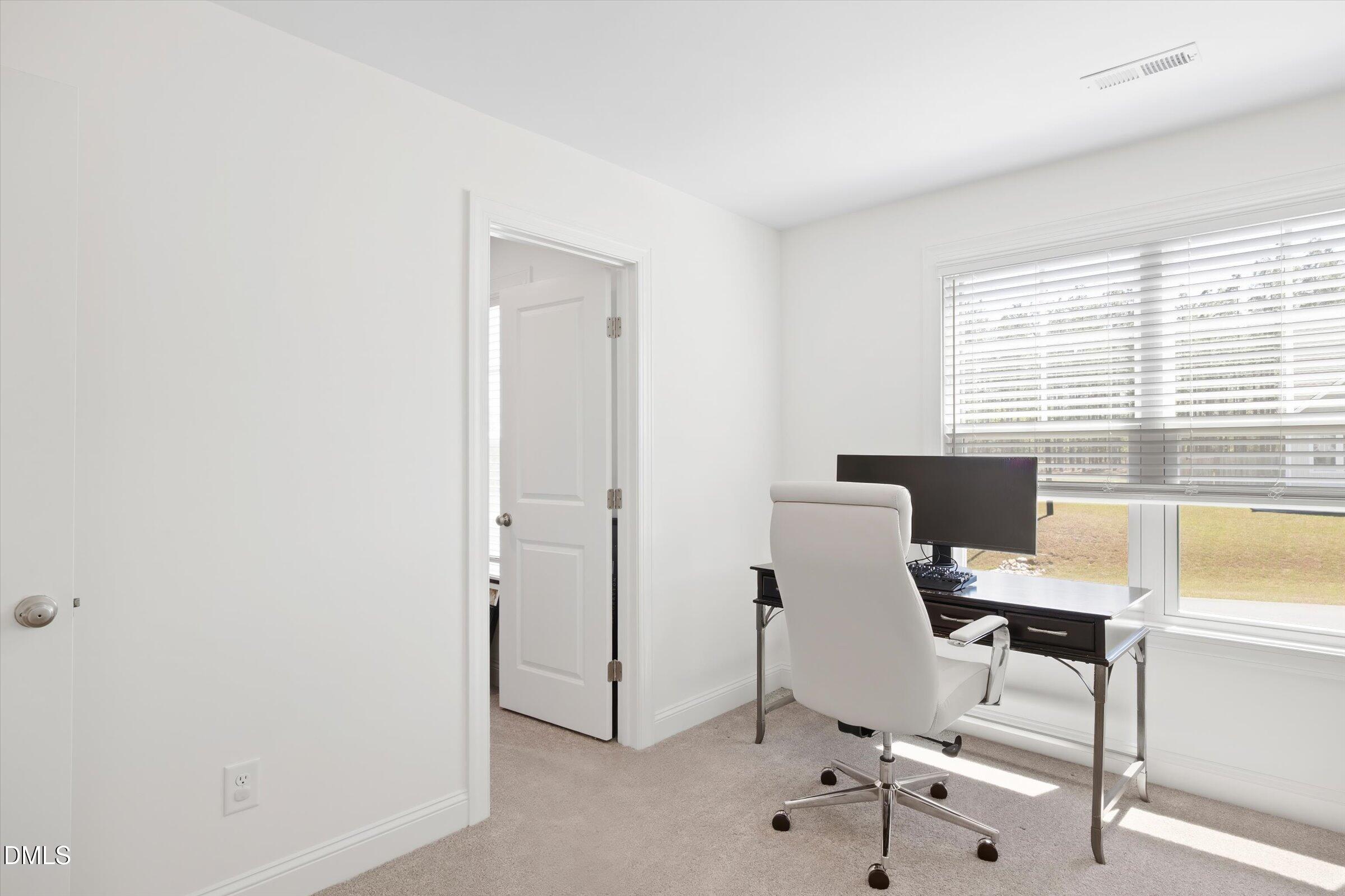 116 Nairn Street Fayetteville, NC 28311 - Photo 32 of 56 a view of a workspace with furniture and a window