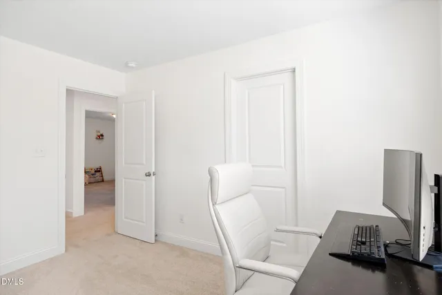 a bedroom with a bed and a flat tv screen on a dresser