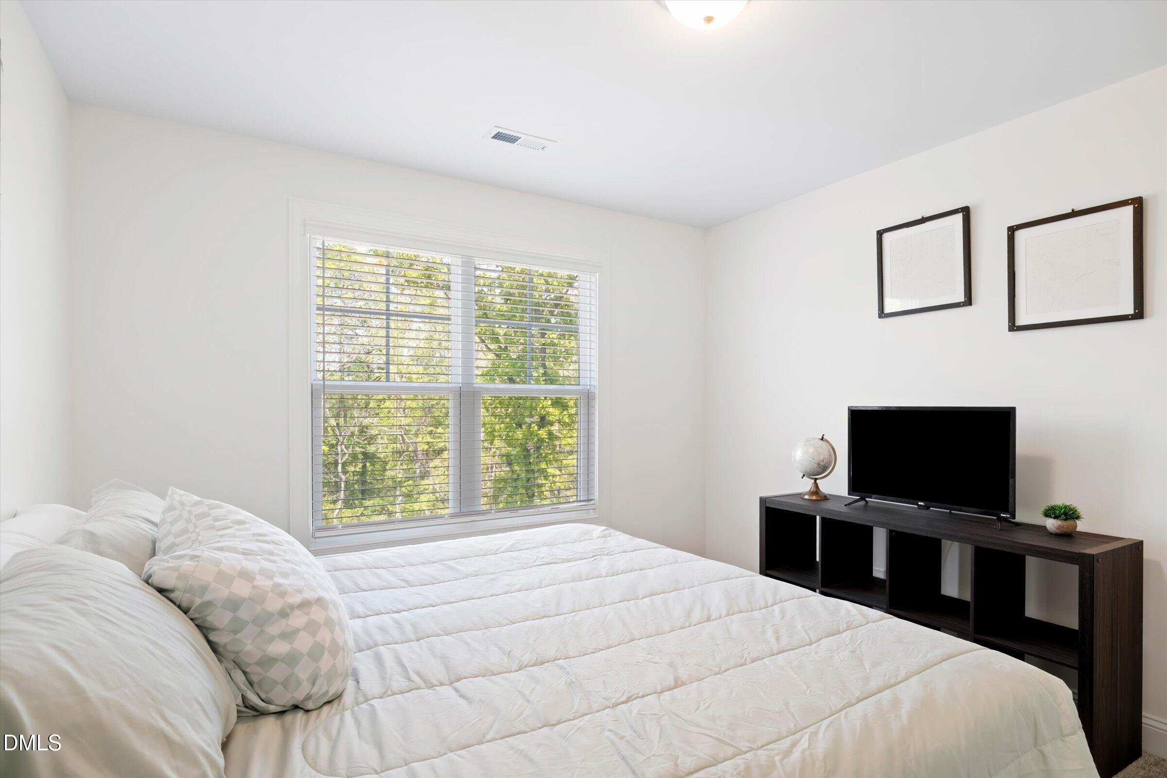 116 Nairn Street Fayetteville, NC 28311 - Photo 36 of 56 a bedroom with a bed and a flat screen tv