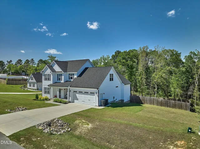 a front view of house with yard and green space