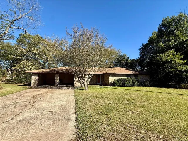 a white house that has a tree in front of it