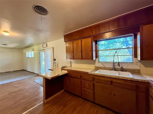 a kitchen with a sink and wooden cabinets