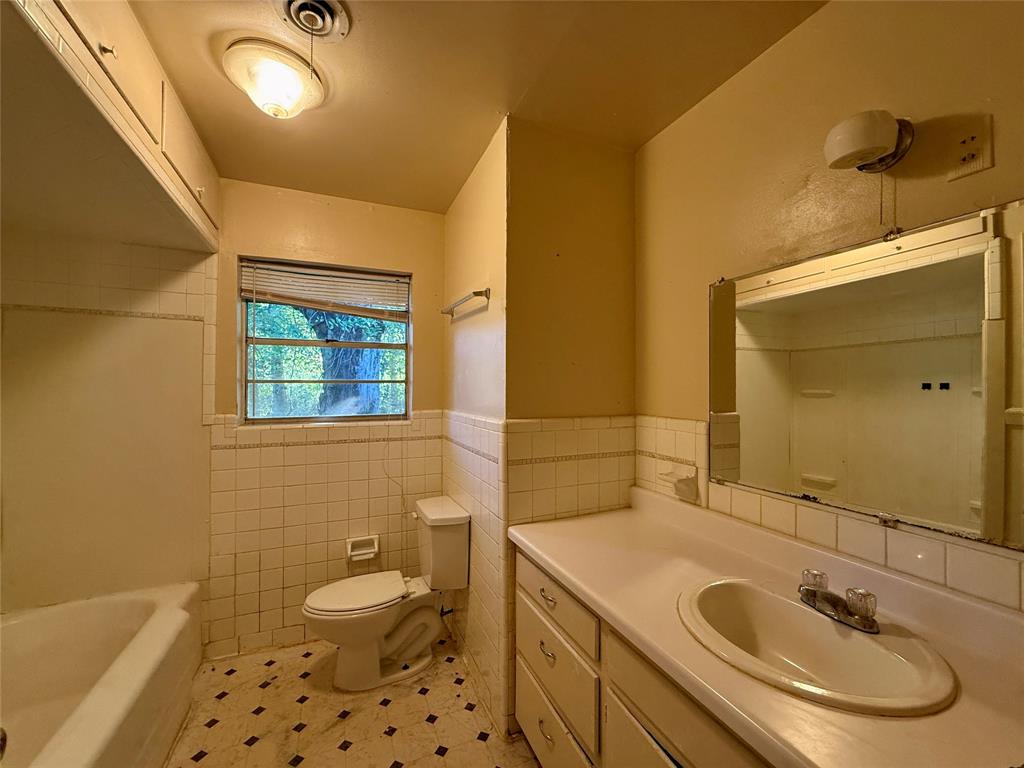 208 West Main Street Cumby, TX 75433 - Photo 18 of 24 a bathroom with a sink a toilet and shower