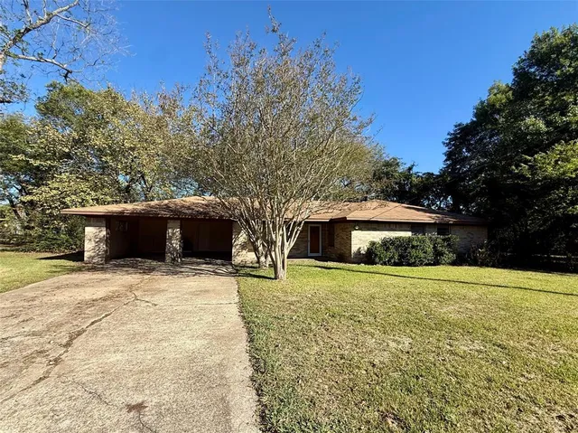 a front view of house with yard and trees