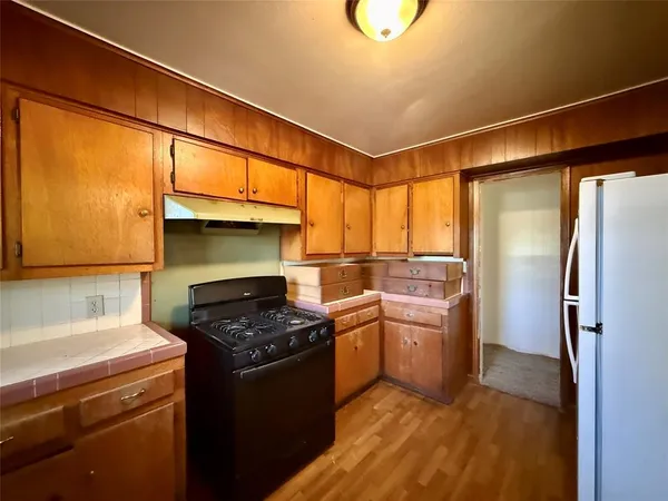 a kitchen with a stove a refrigerator and a sink