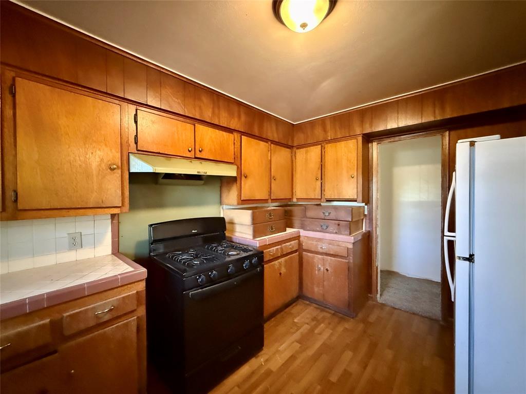 208 West Main Street Cumby, TX 75433 - Photo 10 of 24 a kitchen with a stove a refrigerator and a sink