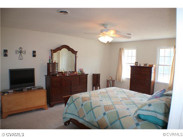 5508 Takach Road Prince George, VA 23875 - Photo 8 of 11 a bedroom with a bed and a flat screen tv