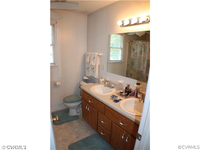 5508 Takach Road Prince George, VA 23875 - Photo 9 of 11 a bathroom with a toilet a sink a mirror and vanity