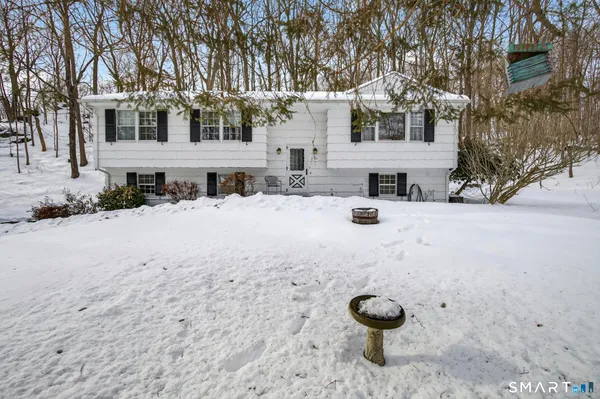 a view of a house with snow ground and yard