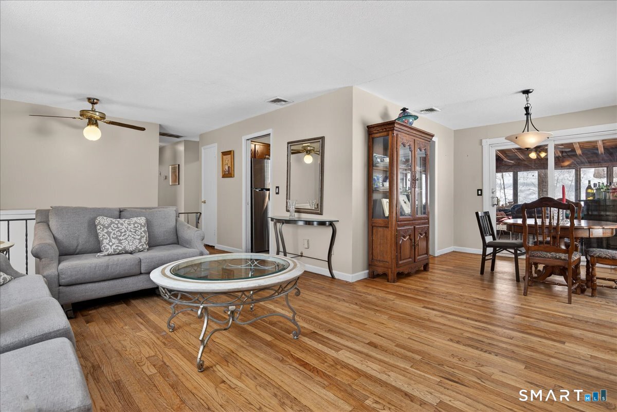 31 Longview Drive Ridgefield, CT 06877 - Photo 13 of 39 a living room with furniture a dining table and chairs with wooden floor
