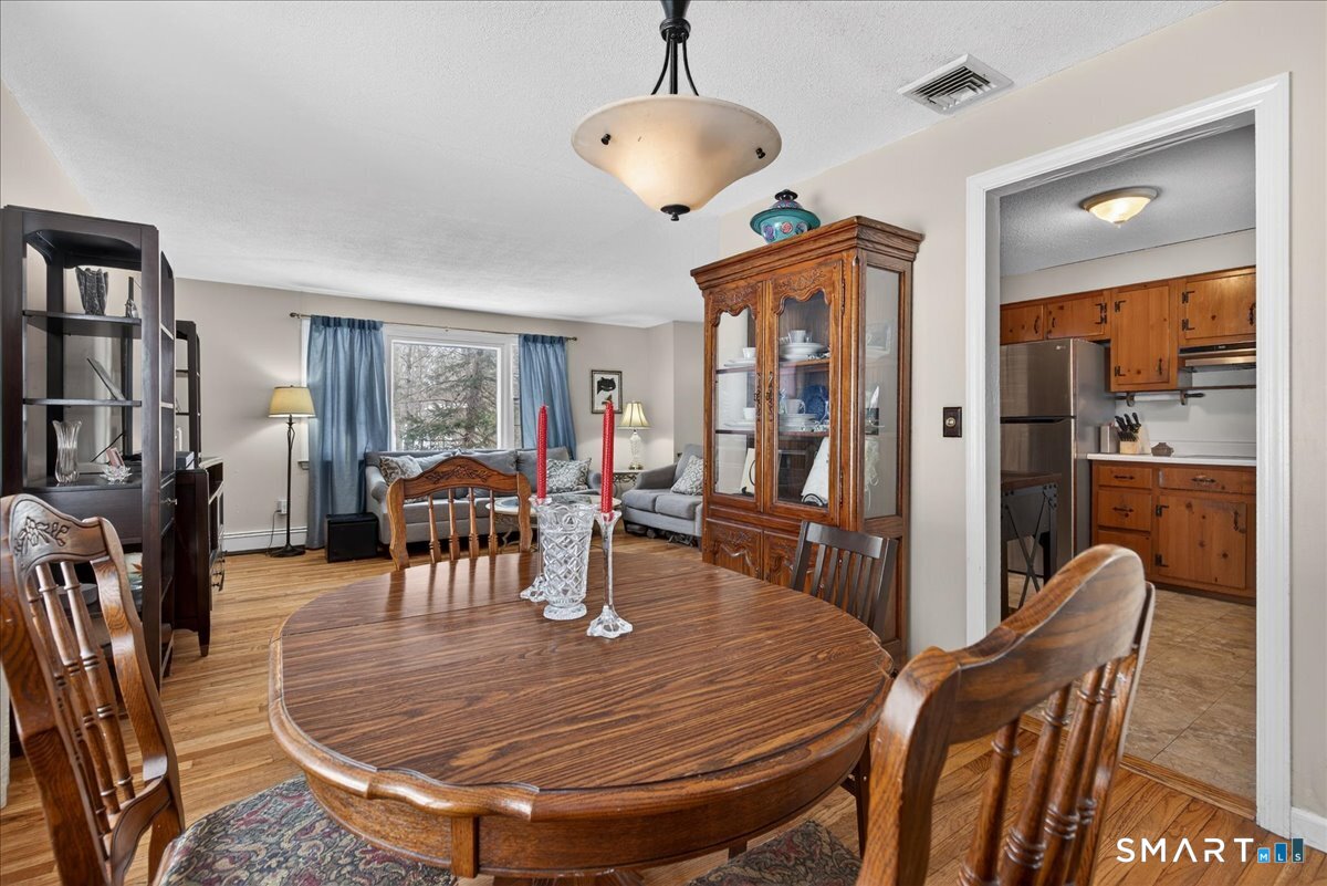 31 Longview Drive Ridgefield, CT 06877 - Photo 19 of 39 a dining room with furniture a chandelier and wooden floor