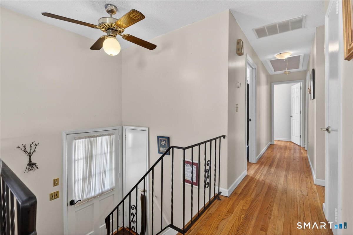 31 Longview Drive Ridgefield, CT 06877 - Photo 25 of 39 a view of a hallway with wooden floor and staircase