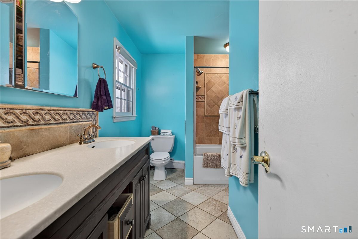 31 Longview Drive Ridgefield, CT 06877 - Photo 28 of 39 a bathroom with a sink and mirror