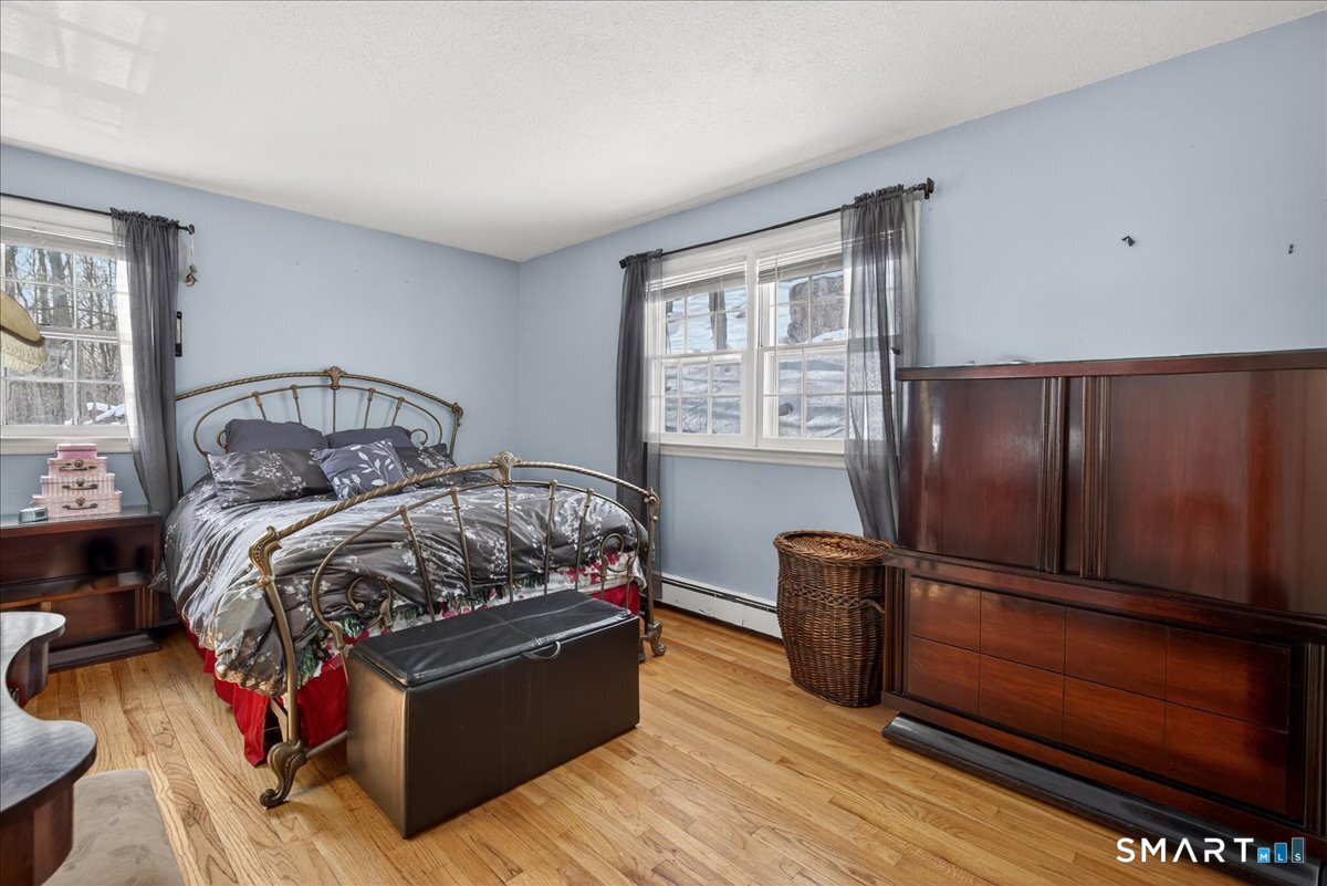 31 Longview Drive Ridgefield, CT 06877 - Photo 30 of 39 a bedroom with bed and wooden floor