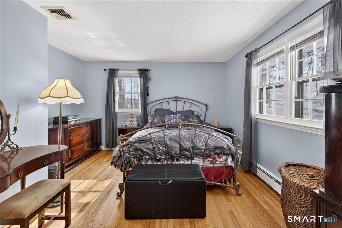 31 Longview Drive Ridgefield, CT 06877 - Photo 31 of 39 a bedroom with a bed and wooden floor