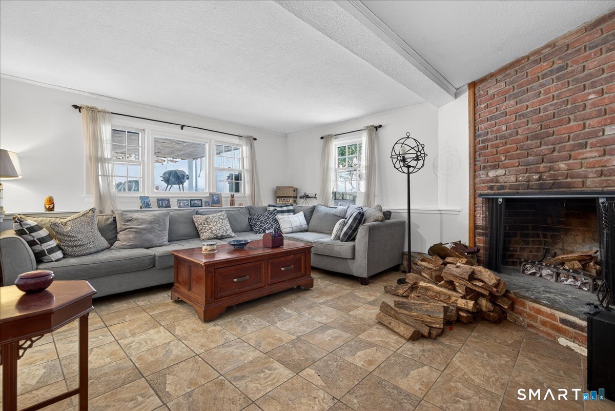 31 Longview Drive Ridgefield, CT 06877 - Photo 38 of 39 a living room with furniture large window and a fireplace