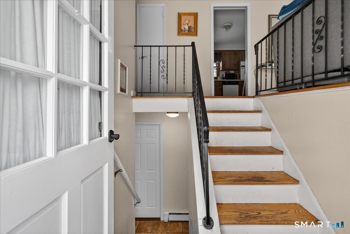 31 Longview Drive Ridgefield, CT 06877 - Photo 5 of 39 a view of staircase with lots of frames on wall and a rug