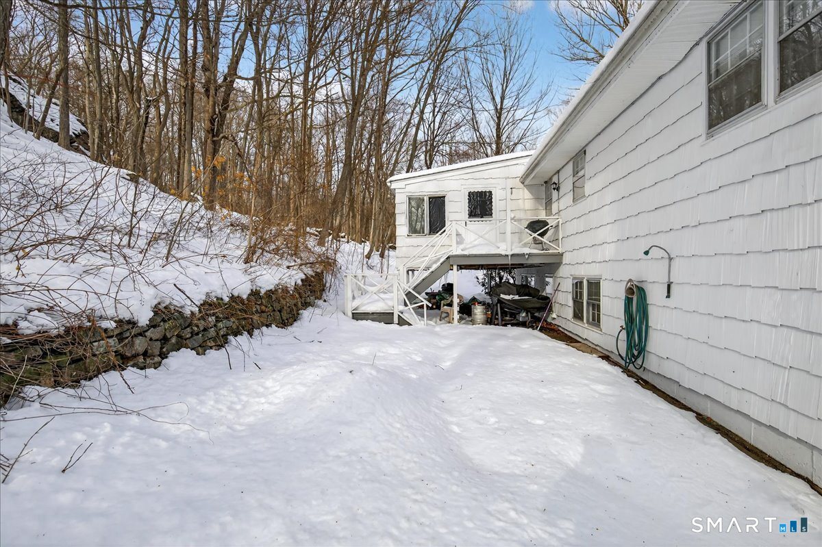31 Longview Drive Ridgefield, CT 06877 - Photo 10 of 39 a view of a house with a snow in the yard