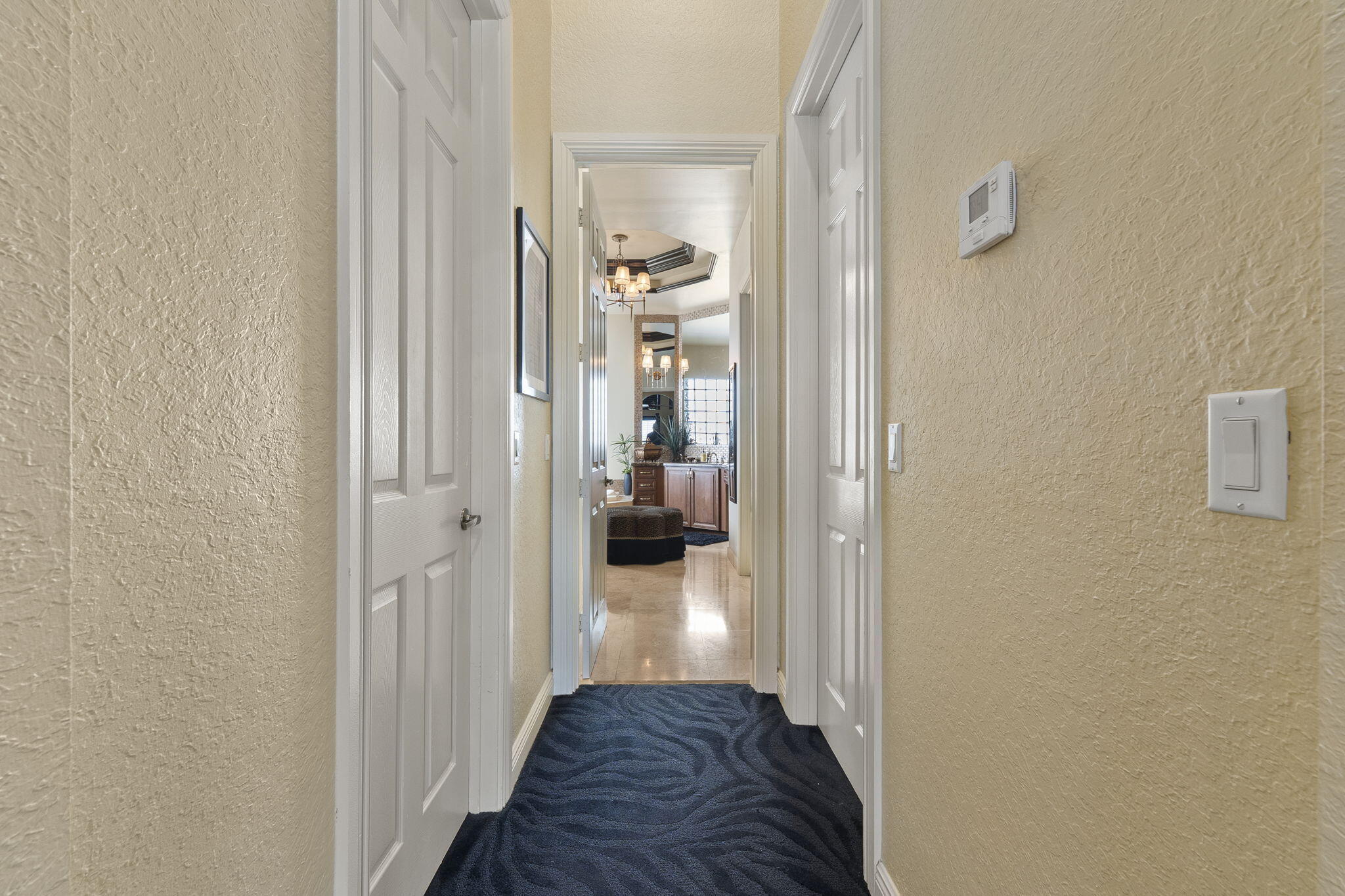 9289 Equus Circle Boynton Beach, FL 33472 - Photo 11 of 72 a view of a hallway with wooden floor a livingroom and furniture