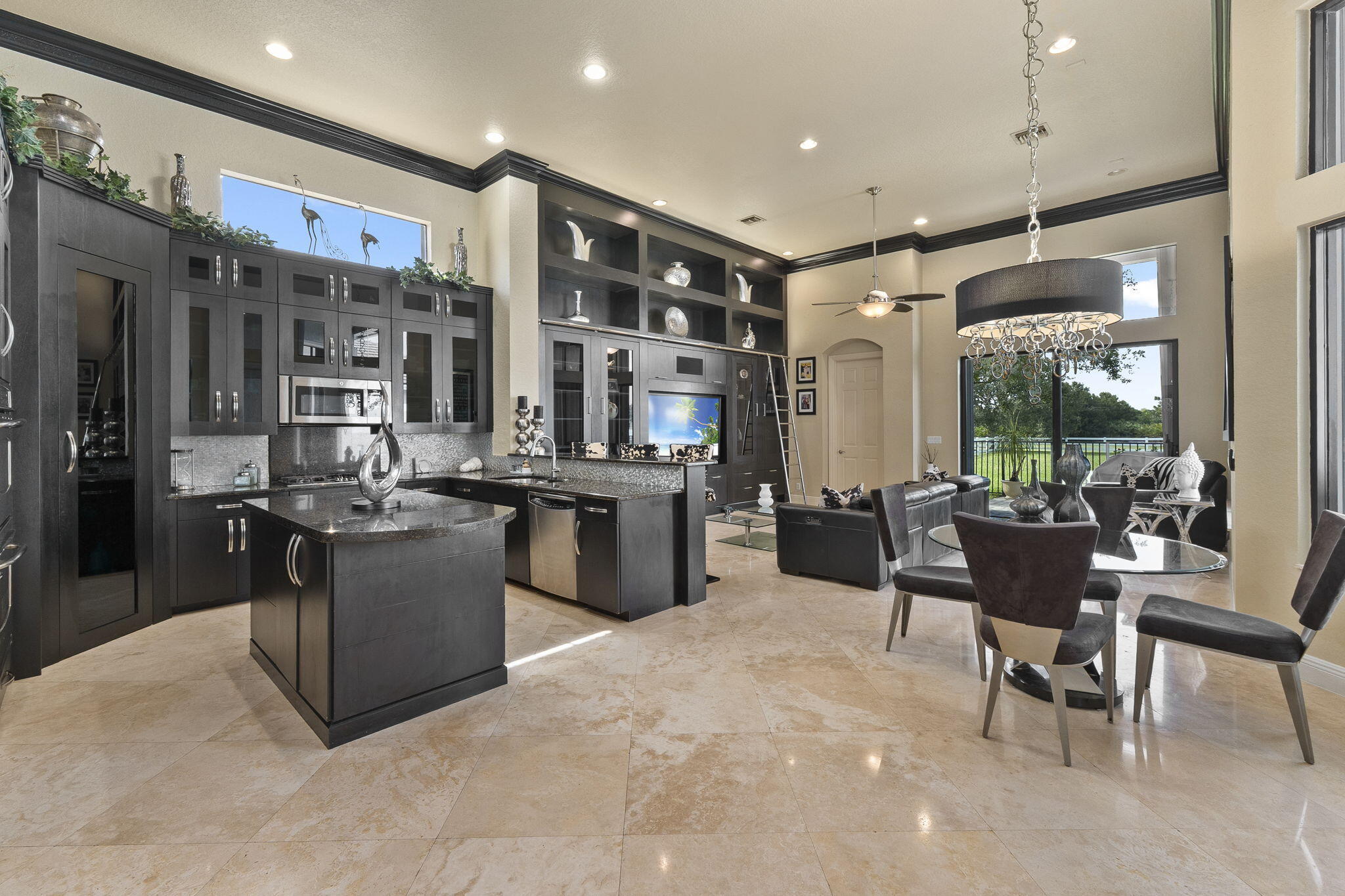 9289 Equus Circle Boynton Beach, FL 33472 - Photo 20 of 72 a kitchen with stainless steel appliances kitchen island granite countertop a table chairs and a refrigerator