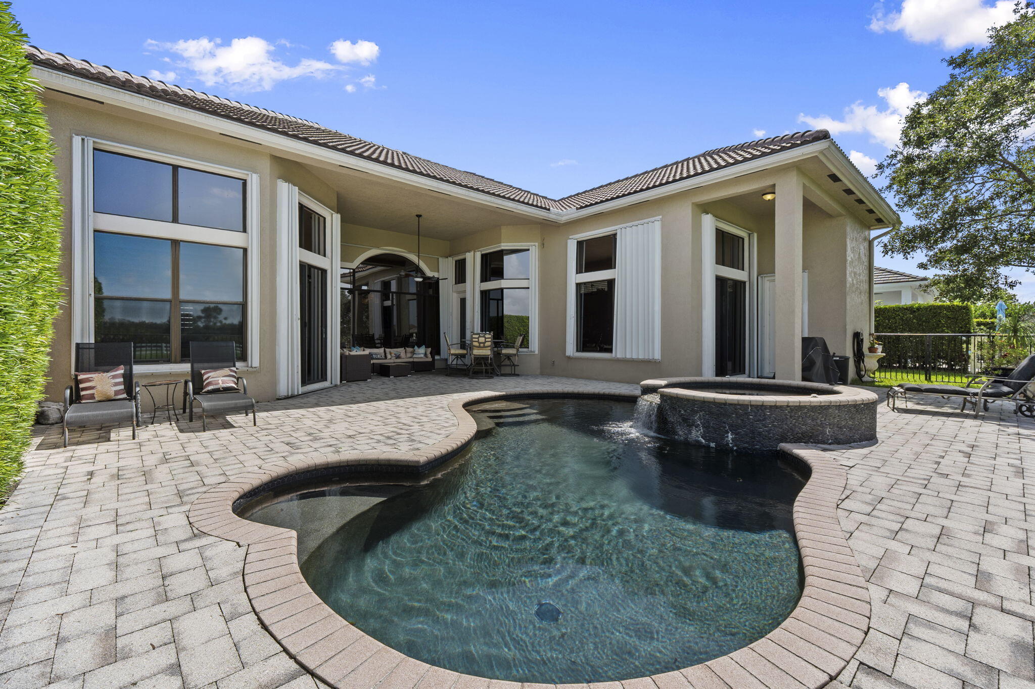 9289 Equus Circle Boynton Beach, FL 33472 - Photo 41 of 72 a view of a house with swimming pool and sitting area