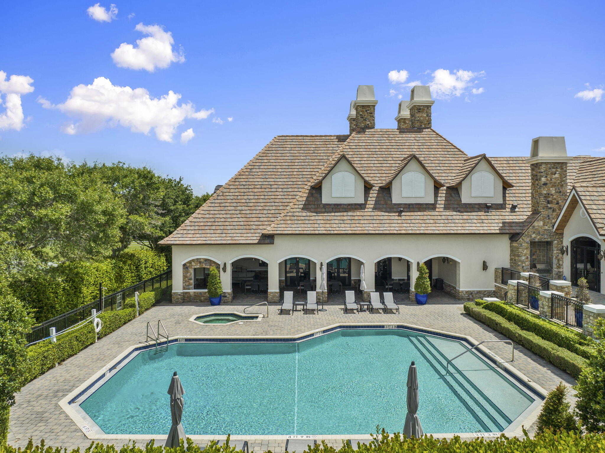 9289 Equus Circle Boynton Beach, FL 33472 - Photo 71 of 72 a view of a white house with a swimming pool and outdoor seating