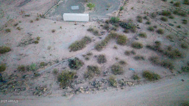 a view of a dry field with lots of bushes