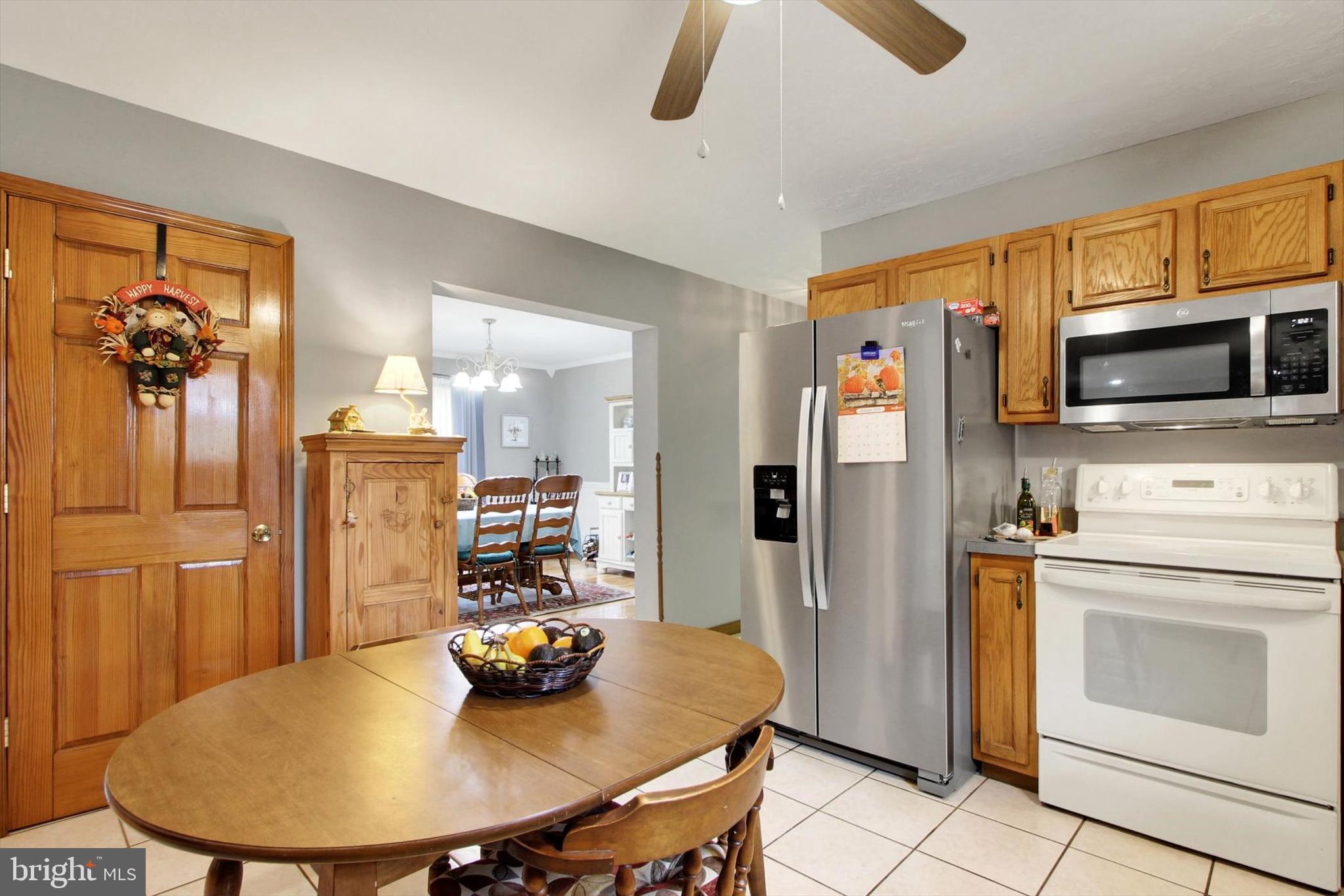 3744 Blue Hill Road Hanover, PA 17331 - Photo 13 of 32 a kitchen with stainless steel appliances kitchen island granite countertop a refrigerator a stove a microwave oven a sink with island and chairs