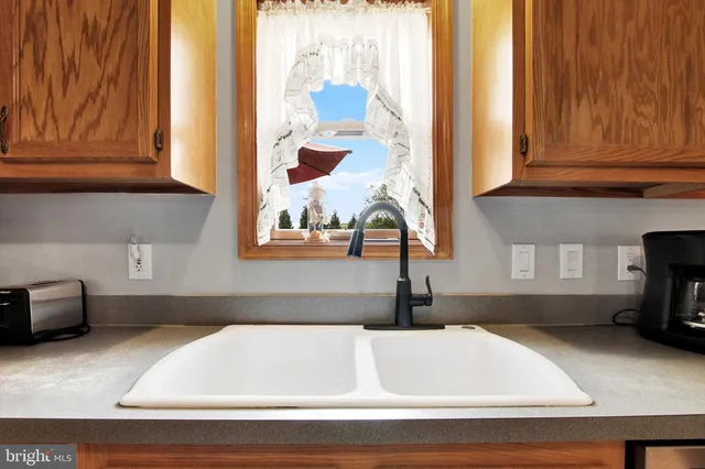 a kitchen with a sink and a window