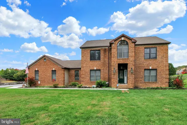 a front view of house with yard and green space