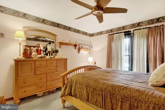 a bedroom with a bed and a ceiling fan
