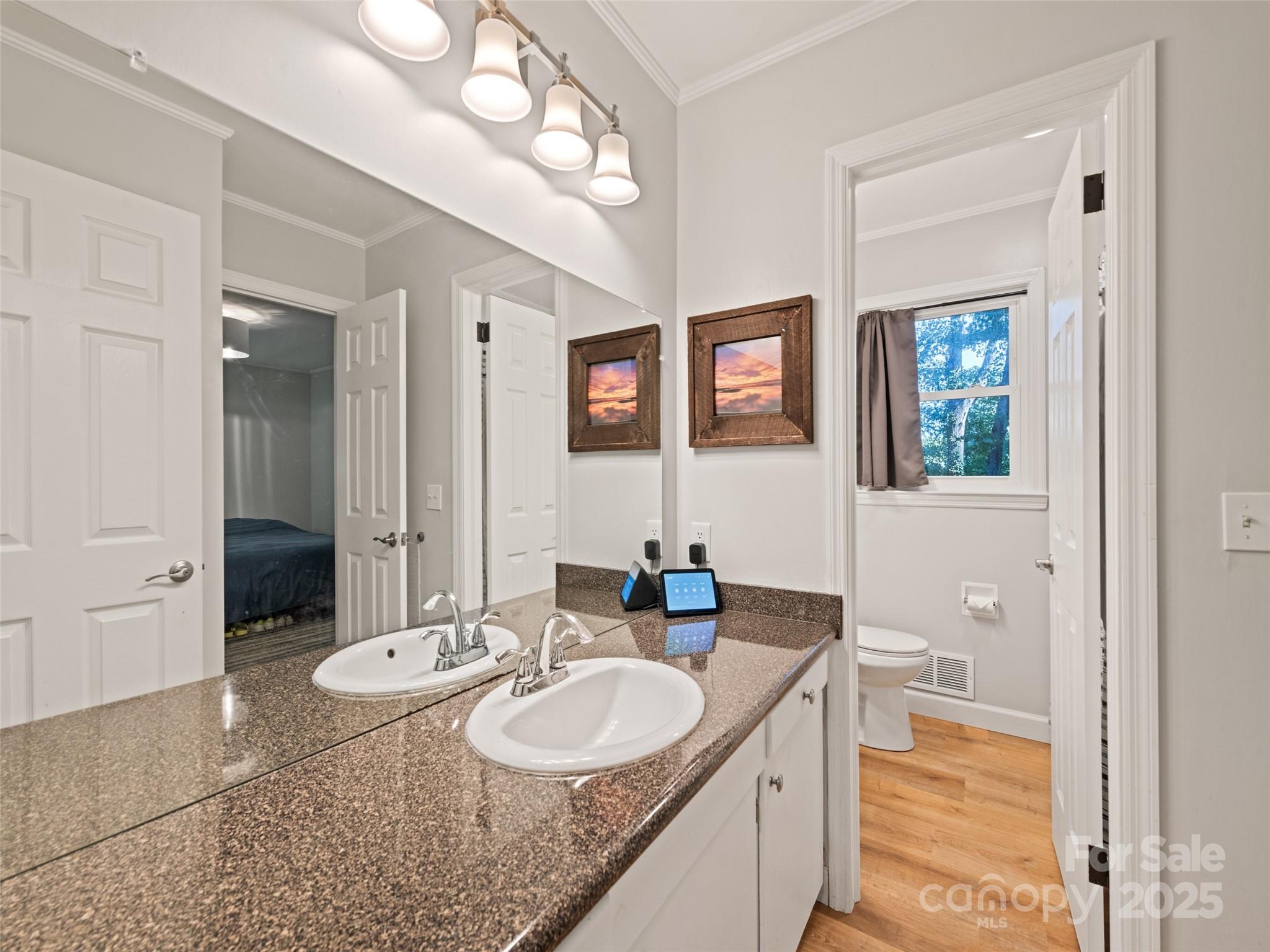 263 Blanton Street Columbus, NC 28722 - Photo 23 of 45 a en suite bathroom with a granite countertop sink and a mirror