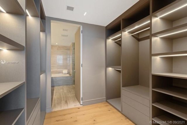 a bathroom with a shower and a glass door