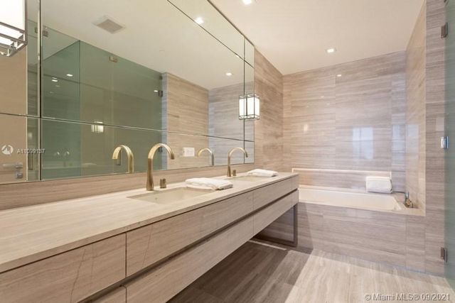 a bathroom with a granite countertop sink a toilet and bathtub