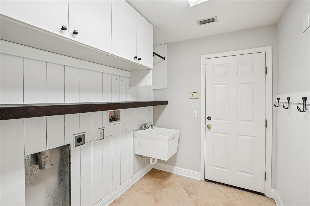 270 Cleveland Avenue Southwest Largo, FL 33770 - Photo 17 of 35 a hallway with white cabinets and entryway
