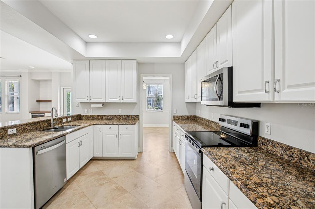 270 Cleveland Avenue Southwest Largo, FL 33770 - Photo 2 of 35 a kitchen with stainless steel appliances granite countertop a stove sink and cabinets