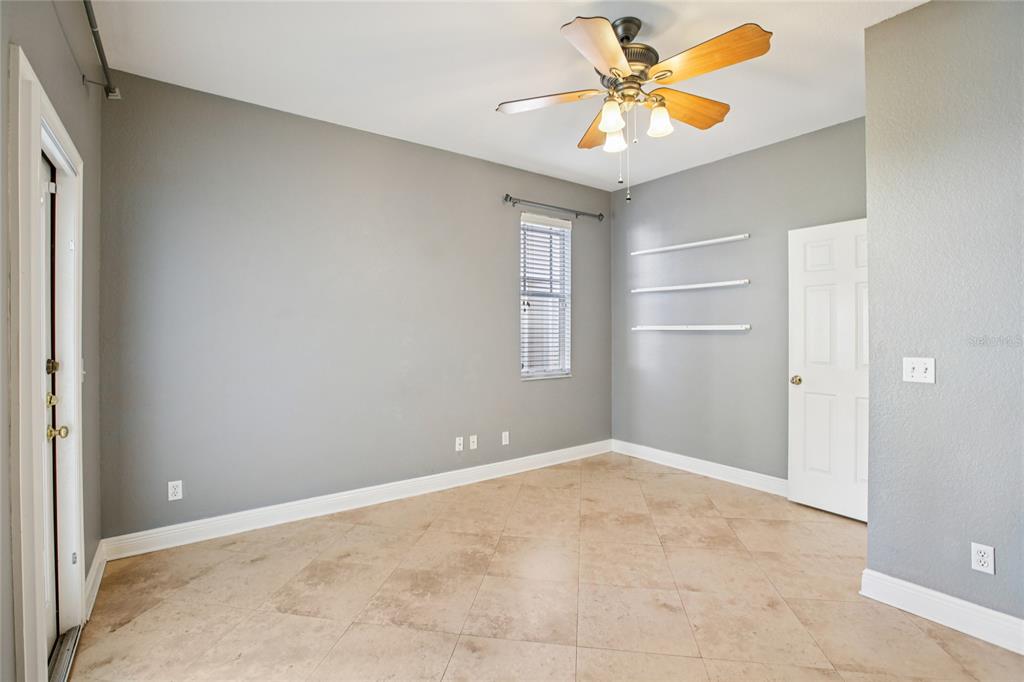 270 Cleveland Avenue Southwest Largo, FL 33770 - Photo 24 of 35 an empty room with windows and fan