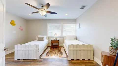 a bedroom with a bed and wooden floor