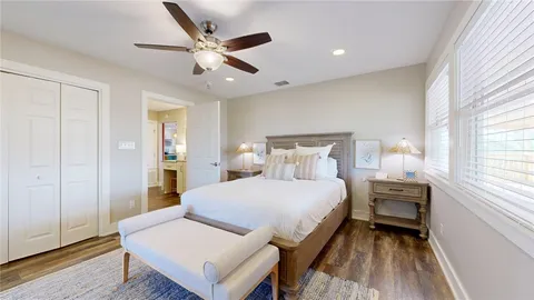 a bedroom with a bed and a large window