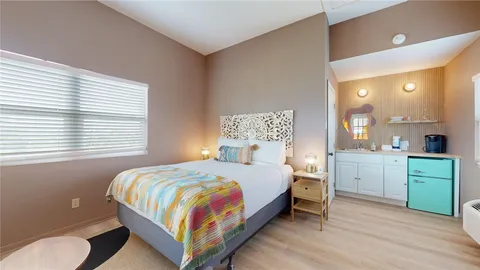 a bedroom with a bed and a dresser