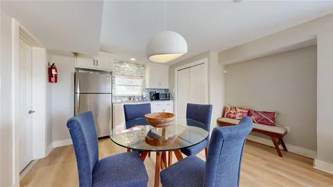 a view of a dining room with furniture window and wooden floor