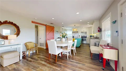 a dining room with furniture and wooden floor