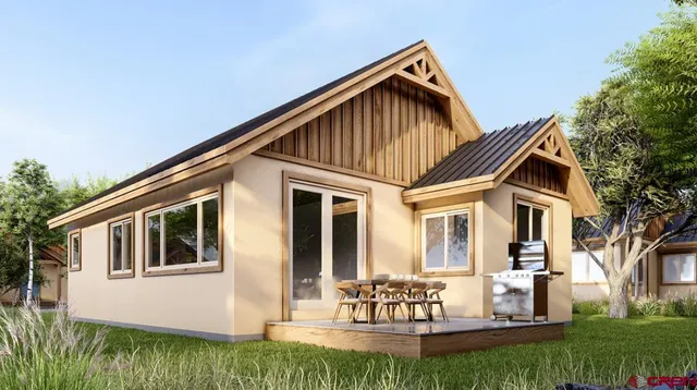 a front view of a house with a yard table and chairs