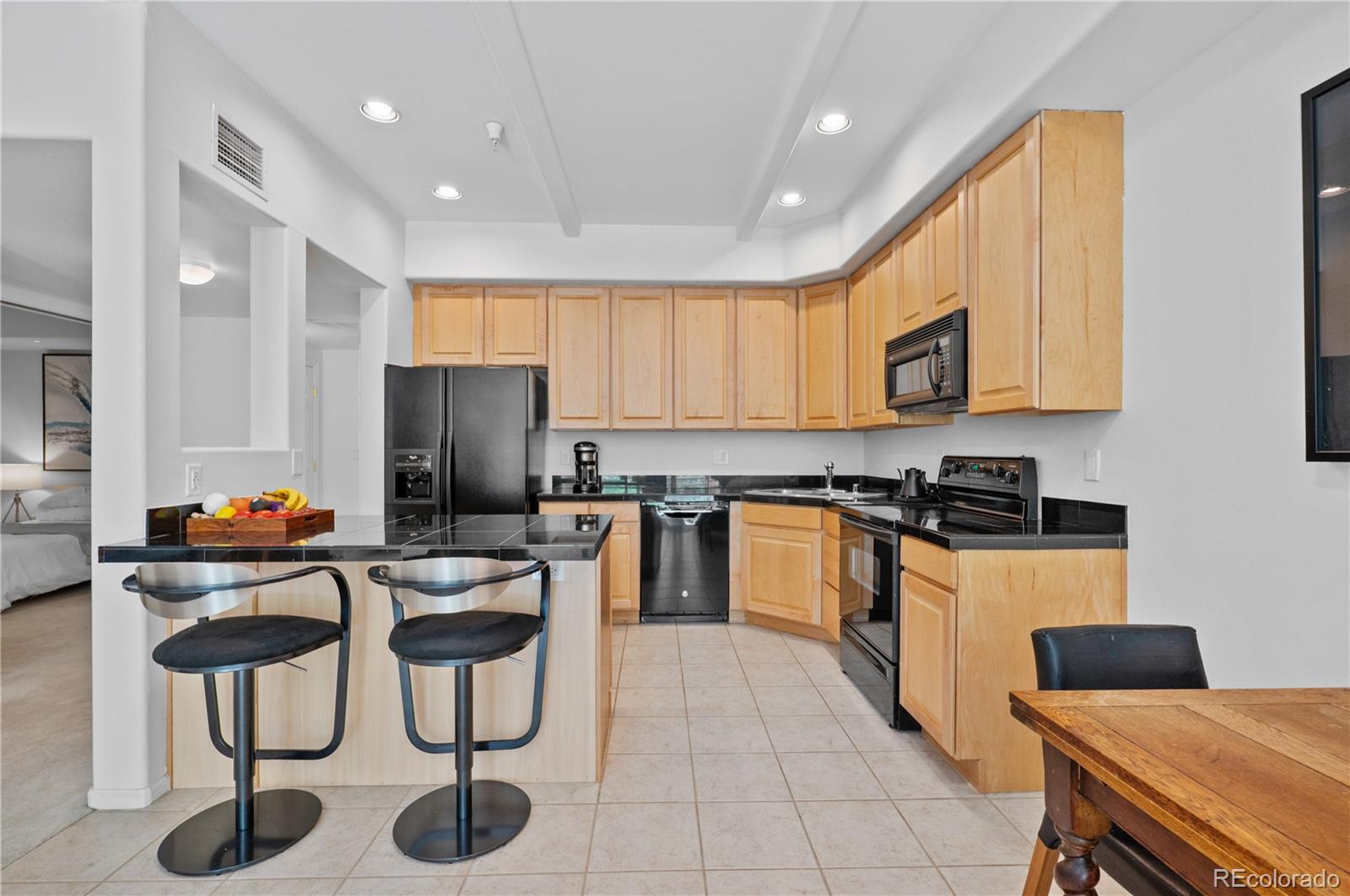 180 Cook Street, Unit 203 Denver, CO 80206 - Photo 13 of 44 a kitchen with stainless steel appliances granite countertop a stove a sink and a refrigerator