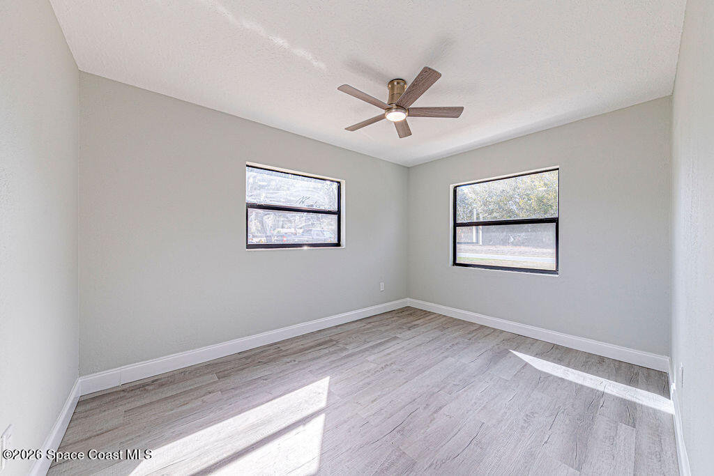 2773 Hickory Circle Mims, FL 32754 - Photo 19 of 45 a view of a big room with wooden floor and windows